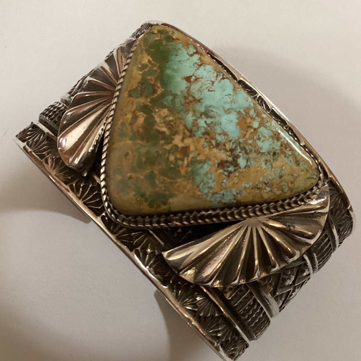 Bracelet, stamped wide cuff with triangular Royston cab, Adrian Reeves Long - Turquoise Mustang