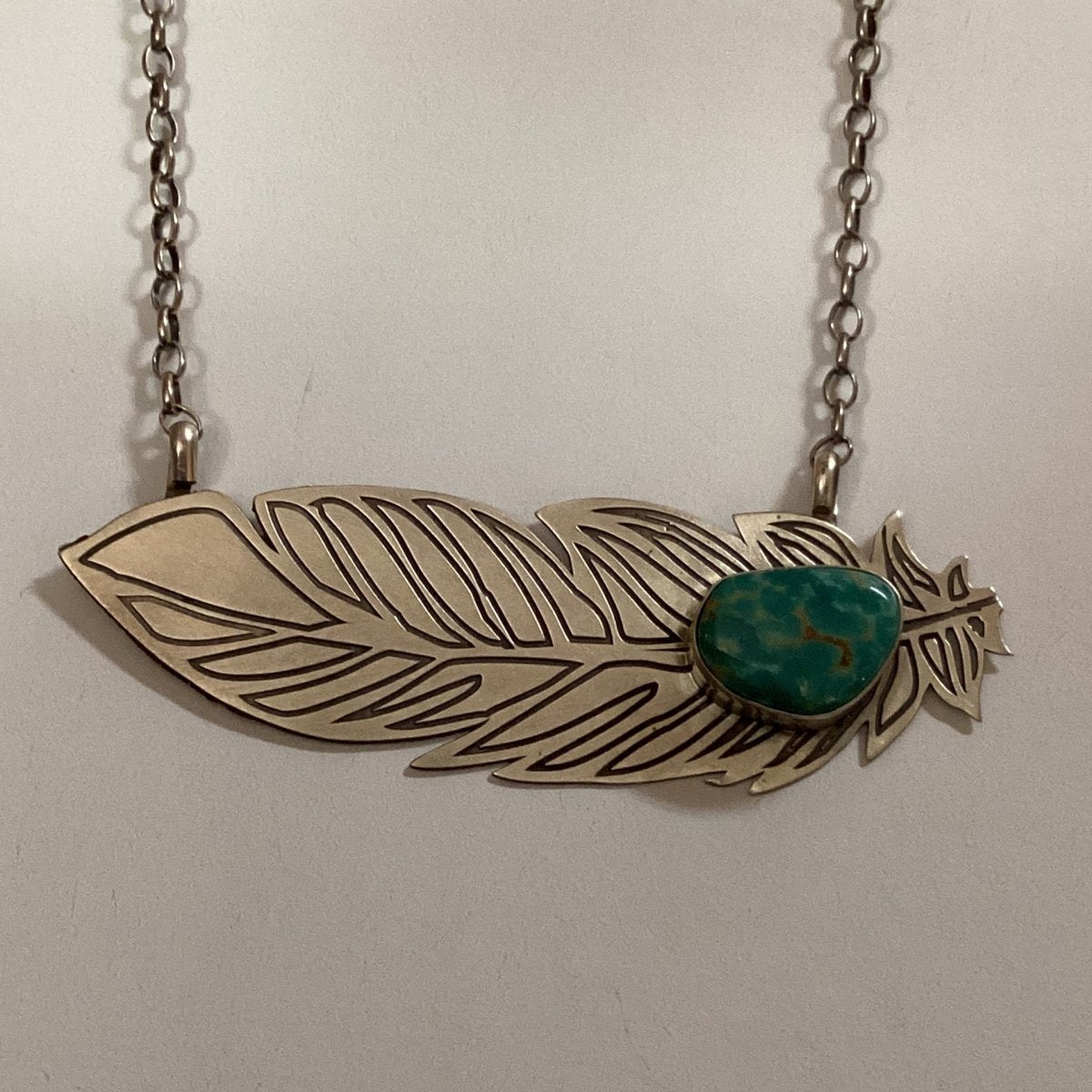 Necklace, etched feather with turquoise cab on chain, unknown - Turquoise Mustang