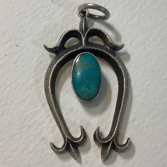Pendant, Naja, Medium Tufa cast with oval turquoise center and Corn Leaves, DD - Turquoise Mustang